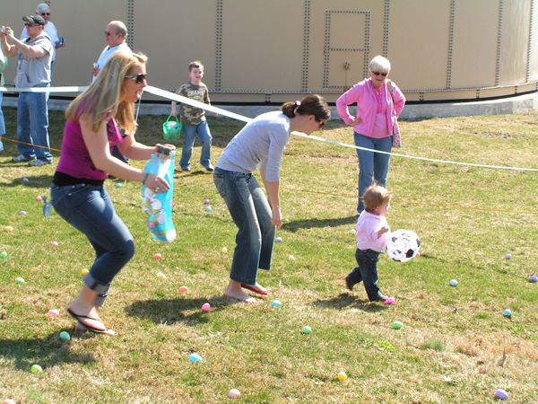 Adult helping with egg hunt